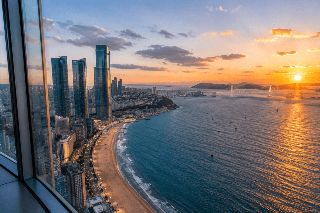 Panoramic sunset view from Busan X the Sky over Haeundae Beach, ocean, skyline, and Gwangan Bridge