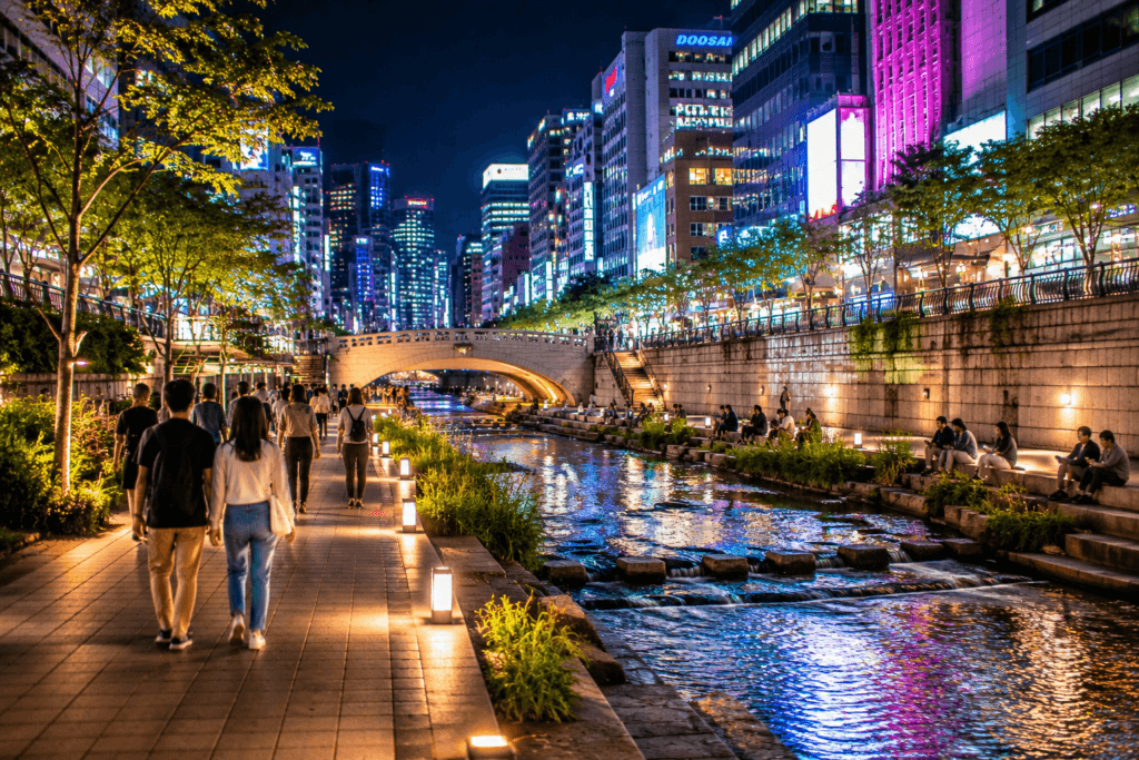 Cheonggyecheon Stream near Dongdaemun at night with people walking beside the water