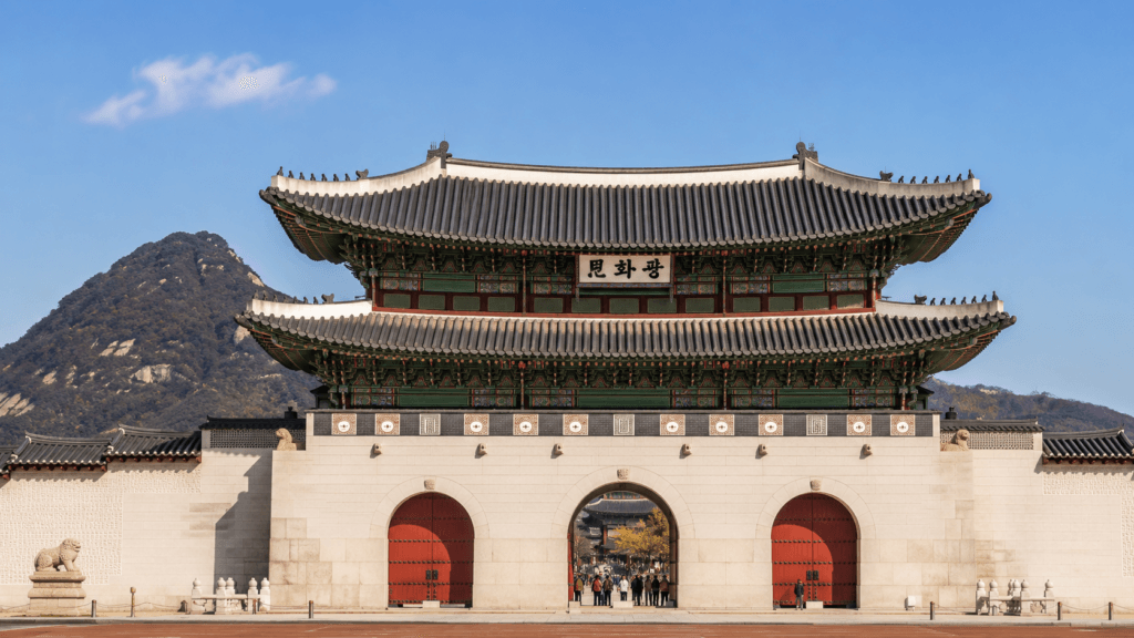 Gwanghwamun Gate at Gyeongbokgung Palace with mountains in the background in Seoul