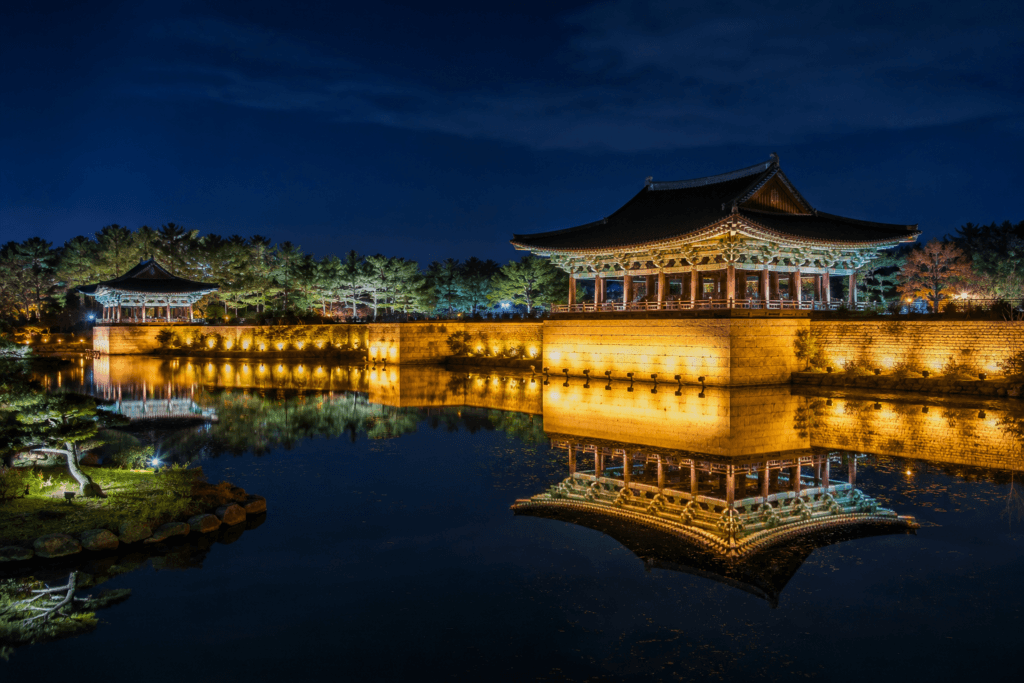 Donggung Palace and Wolji Pond in Gyeongju at night with illuminated pavilions reflected on calm water
