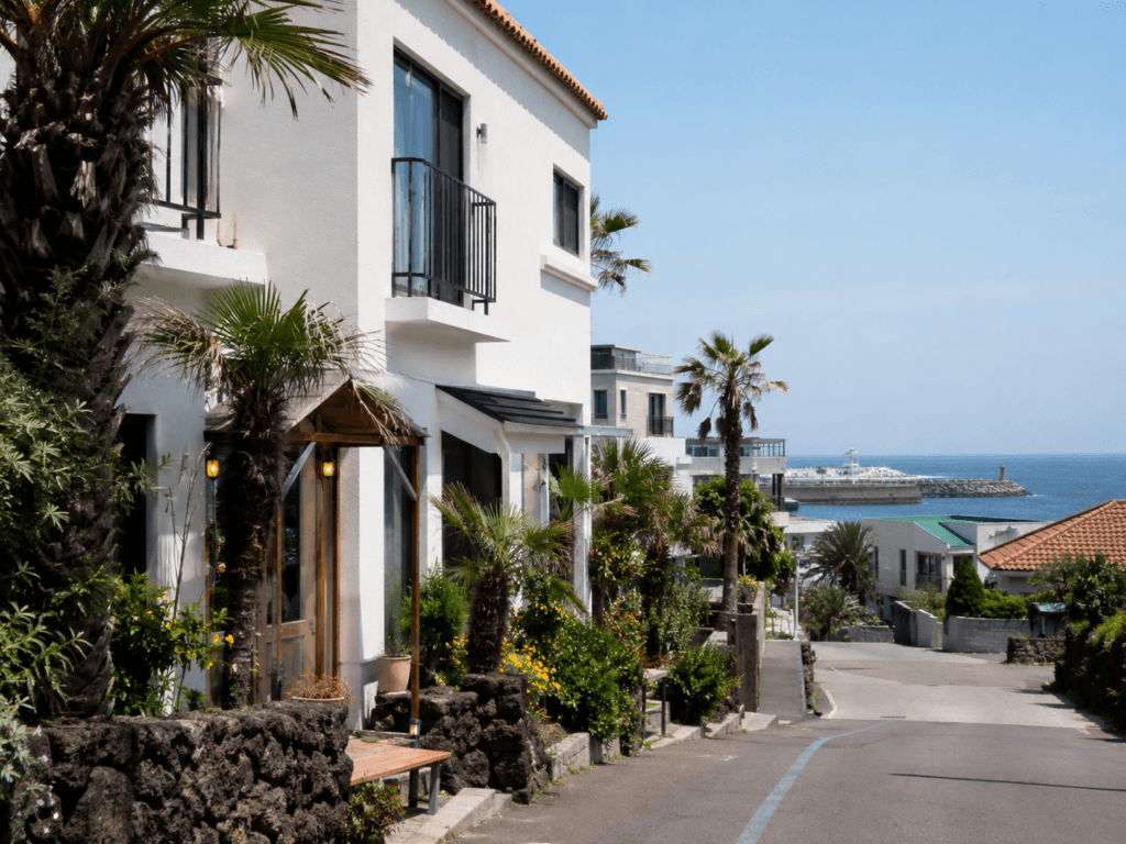 Jeju City Stay Area Near the Airport Jeju City hotel street near the airport with shops, taxis and island city scenery