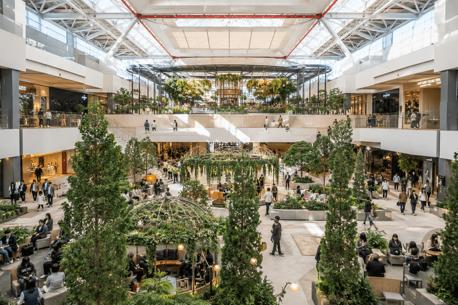 Bright modern interior of The Hyundai Seoul with indoor greenery, open floors, seating areas and shoppers