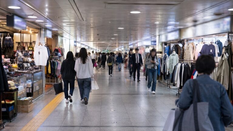 Gangnam Underground Shopping Center corridor with clothing stores and shoppers in Seoul