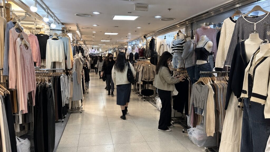 Clothing shops lining a narrow underground shopping corridor at Gangnam Station