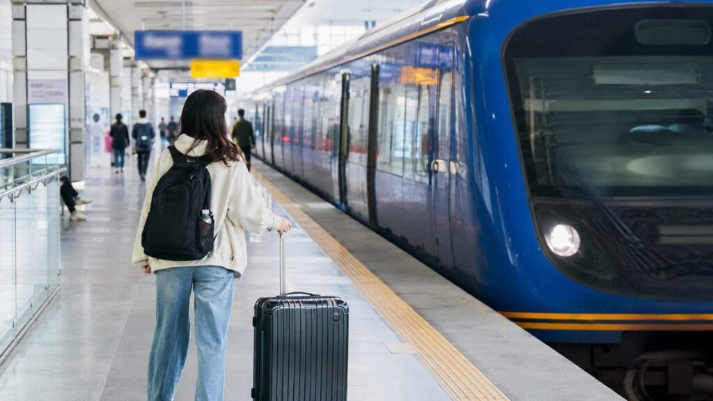 Traveler with luggage beside an AREX train at Incheon Airport