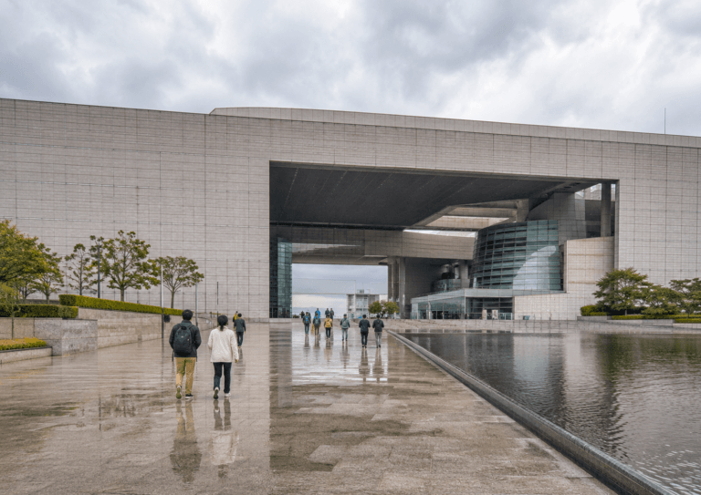 National Museum of Korea guide 2026 with modern museum exterior, rainy plaza, travelers and cloudy Seoul sky