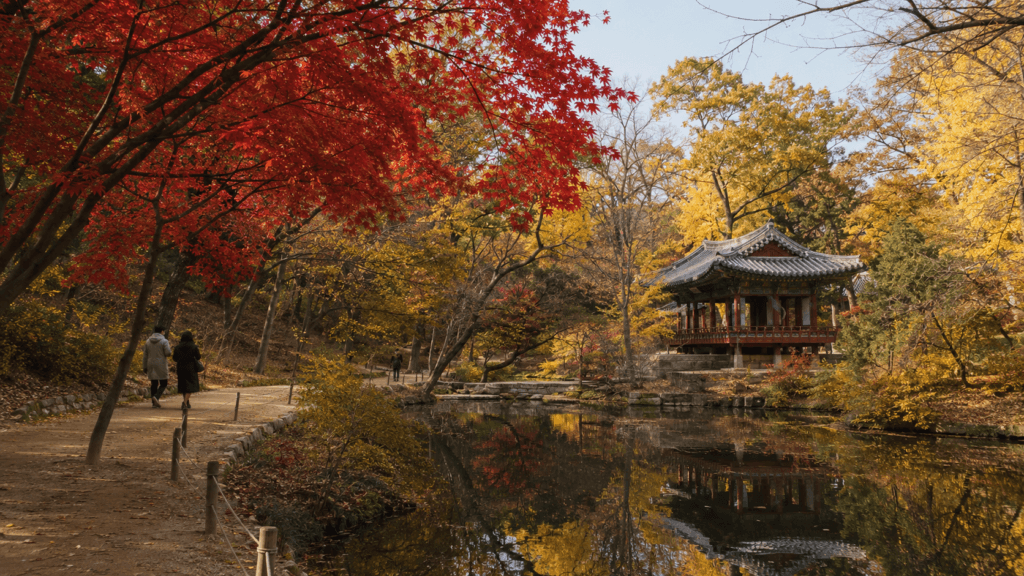 Traditional pavilion and pond surrounded by autumn foliage in Changdeokgung Secret Garden