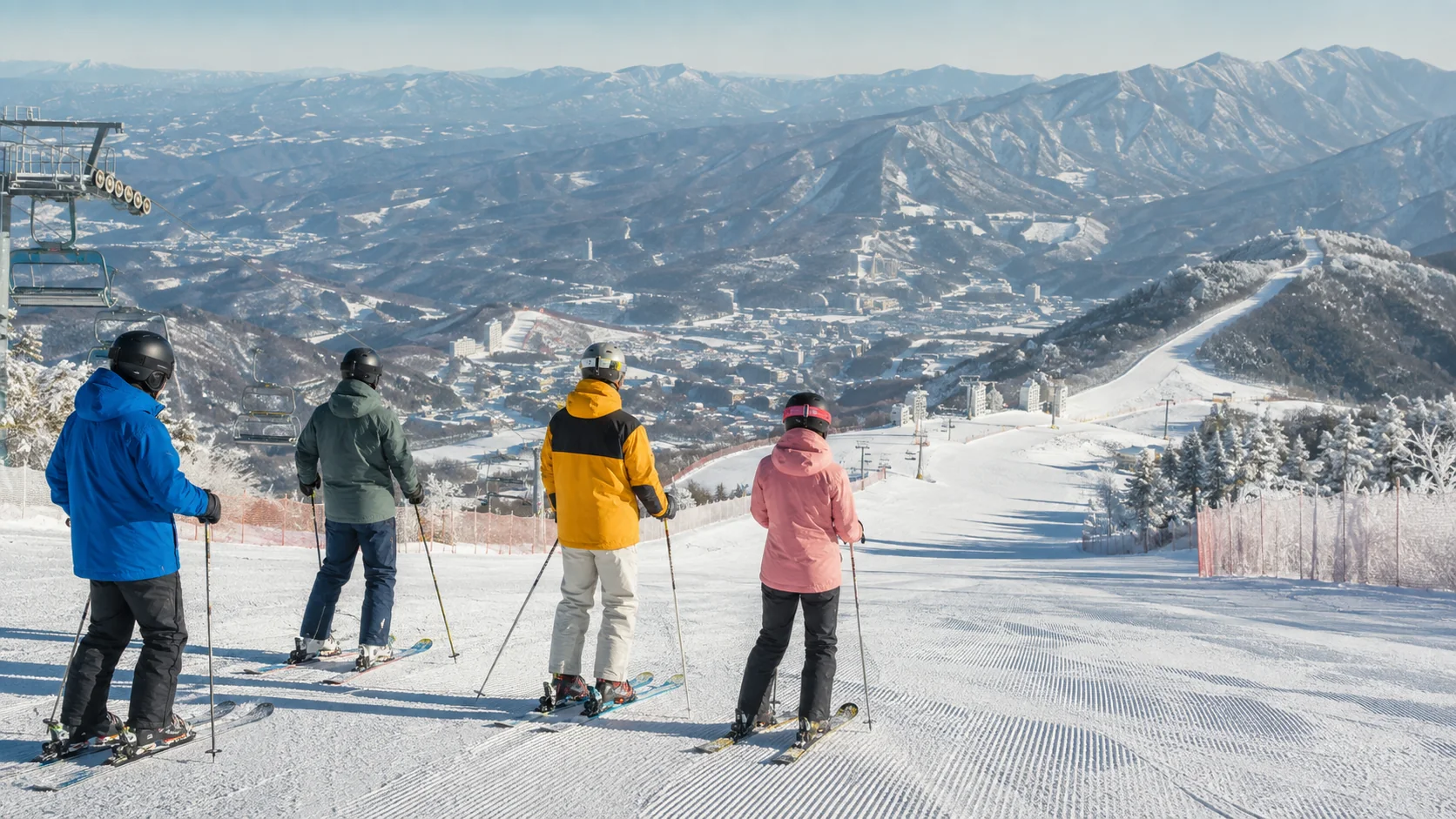 Skiers overlooking snowy mountain slopes at a Korean ski resort
