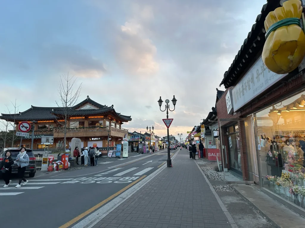Shops, pedestrians and traffic along Hwangnidan-gil in Gyeongju, photographed in January 2025