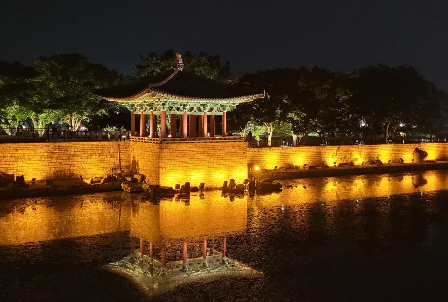 Illuminated pavilion, stone embankment and reflections at Donggung Palace and Wolji Pond at night